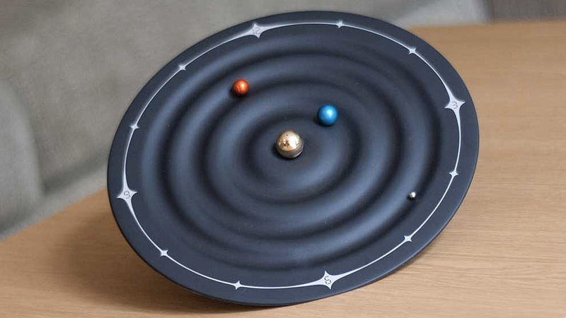 Illustration for article titled Tiny Orbiting Planets Tell the Time On This Solar System Clock